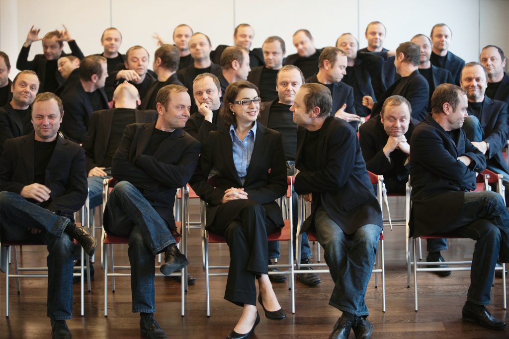 businesswoman surrounded by man 25 times