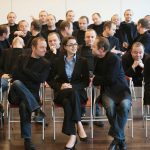 businesswoman surrounded by man 25 times
