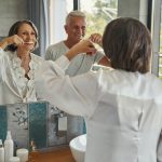 Elderly husband and wife brushing teeth together