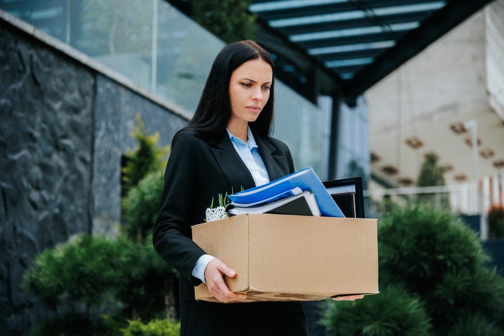 Facing the Loss of a Job Woman Outside with Empty Box