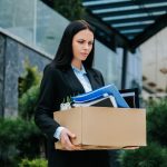 Facing the Loss of a Job Woman Outside with Empty Box