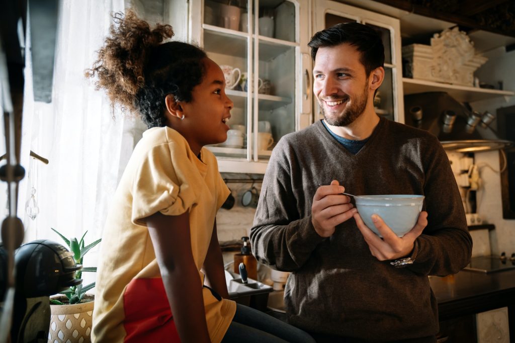 Father talking with his teenager daughter at home