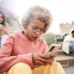 Group of people ignoring each other using phone with serious face